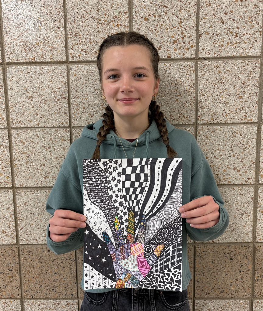 female student holding her hand pattern drawing