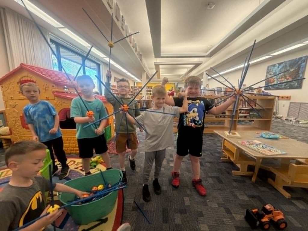 kindergartners built a sphere our of sticks at tehe library