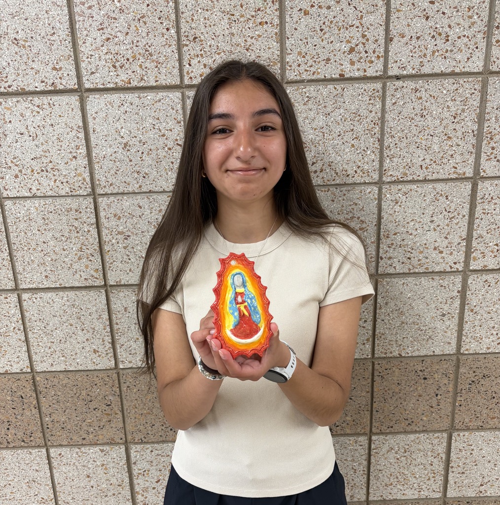 Female 9th grader holding a 3d ornament of Mary