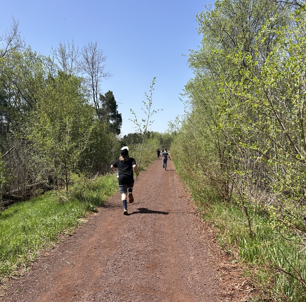 students running down the trail near the school