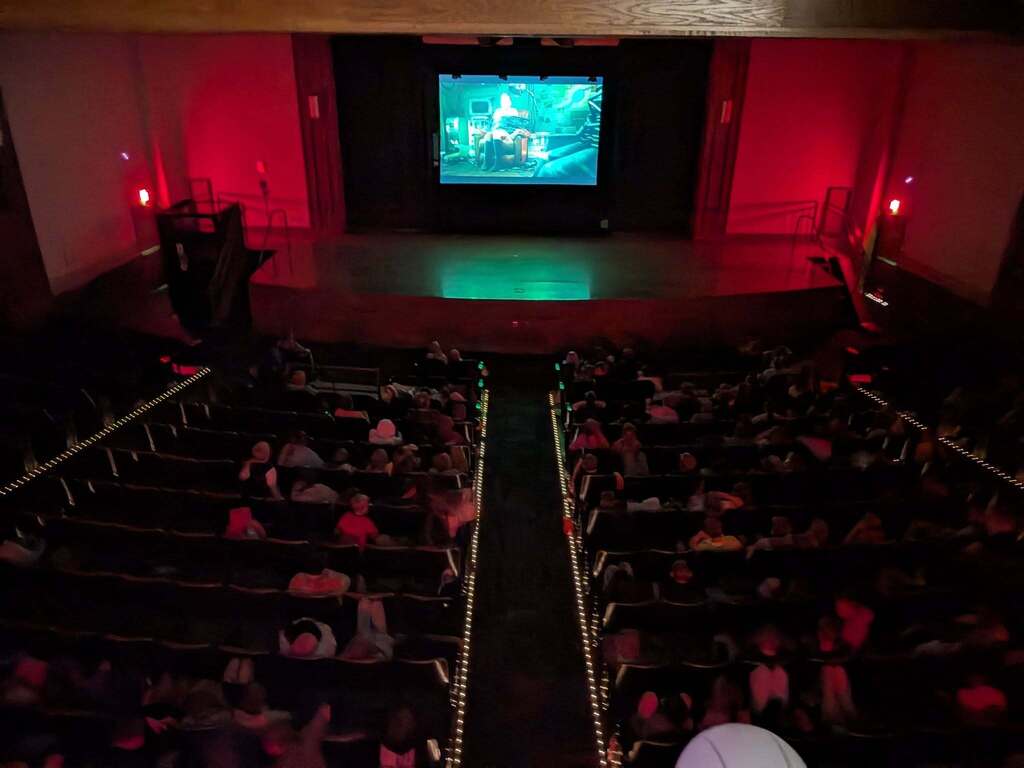 3-6th graders watching the movie Hoppers in the auditorium as their reward