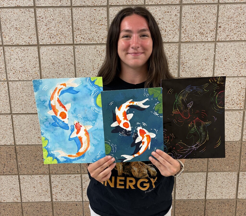 female student holding 3 different but similar paintings
