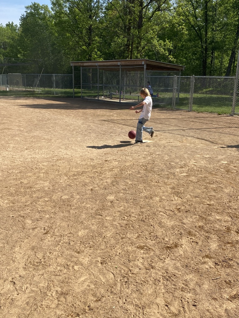 6th grade student kicking the kick ball at home plate