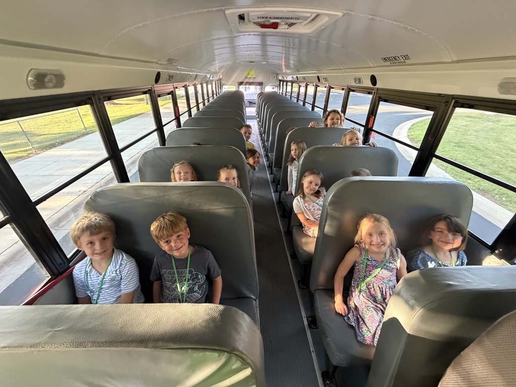 incoming kindergartners sitting on a school bus