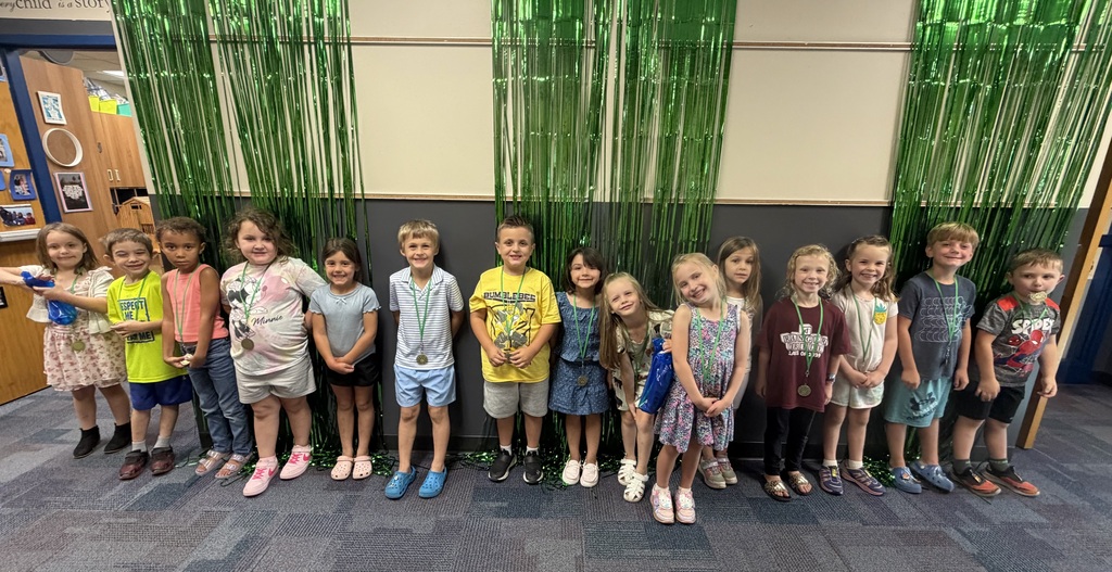 kindergarten students standing on a wall