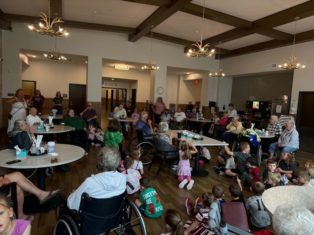 kindergarten classes in a room wtih residents at heartwood