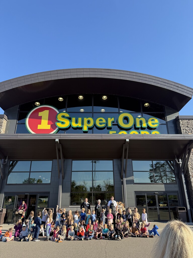 kindergartners and super one staff in front of the store