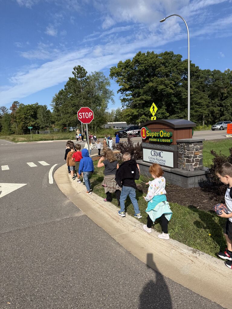 kinders walking on the curb back to CRES from SUper One