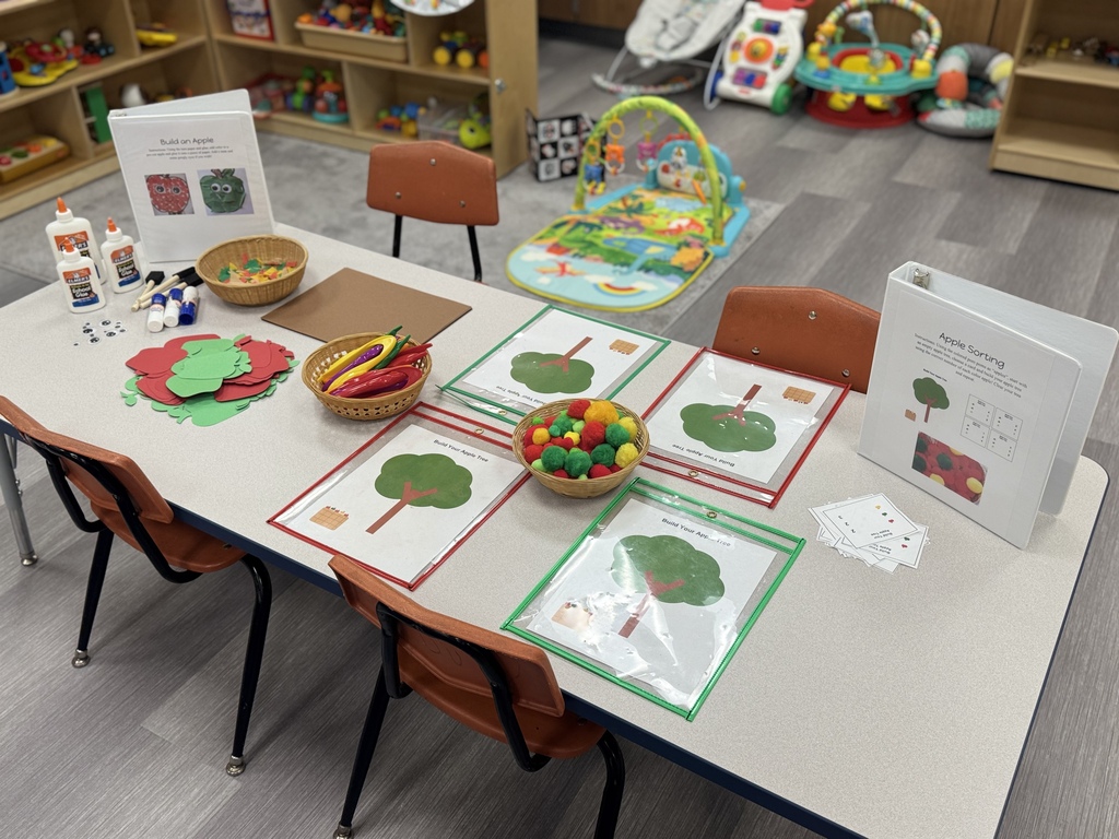 another table set up for ECFE night with apple crafts