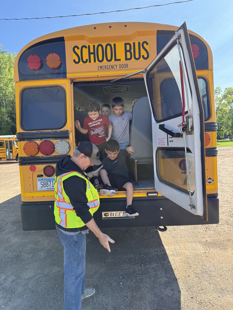 bus driver showing kids how to exit the bus using the back emergency door