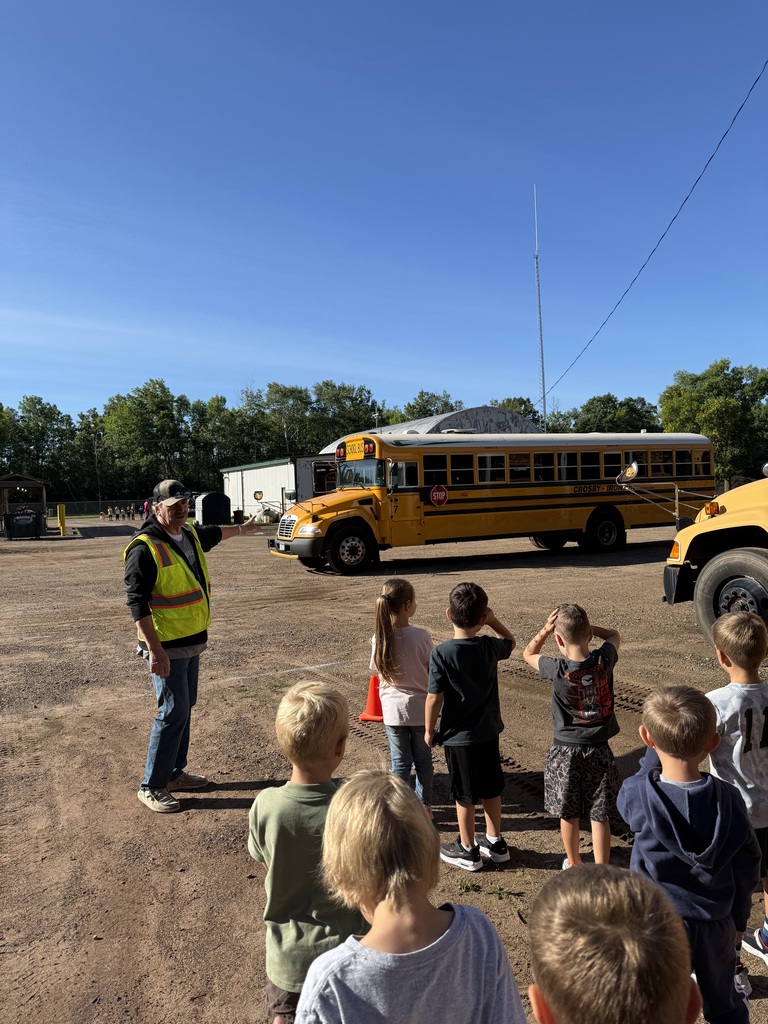 bus driver showing kindergartners how to cross in front of the bus
