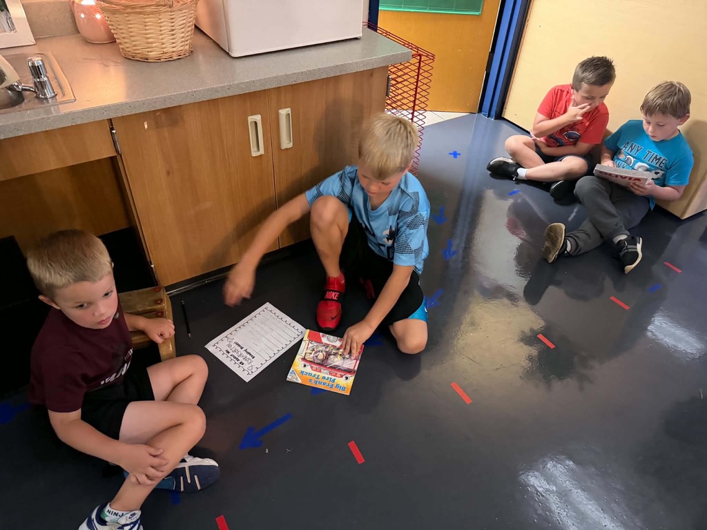 two groups of two boys reading together