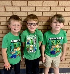 three male students wearing matching minecraft shirts
