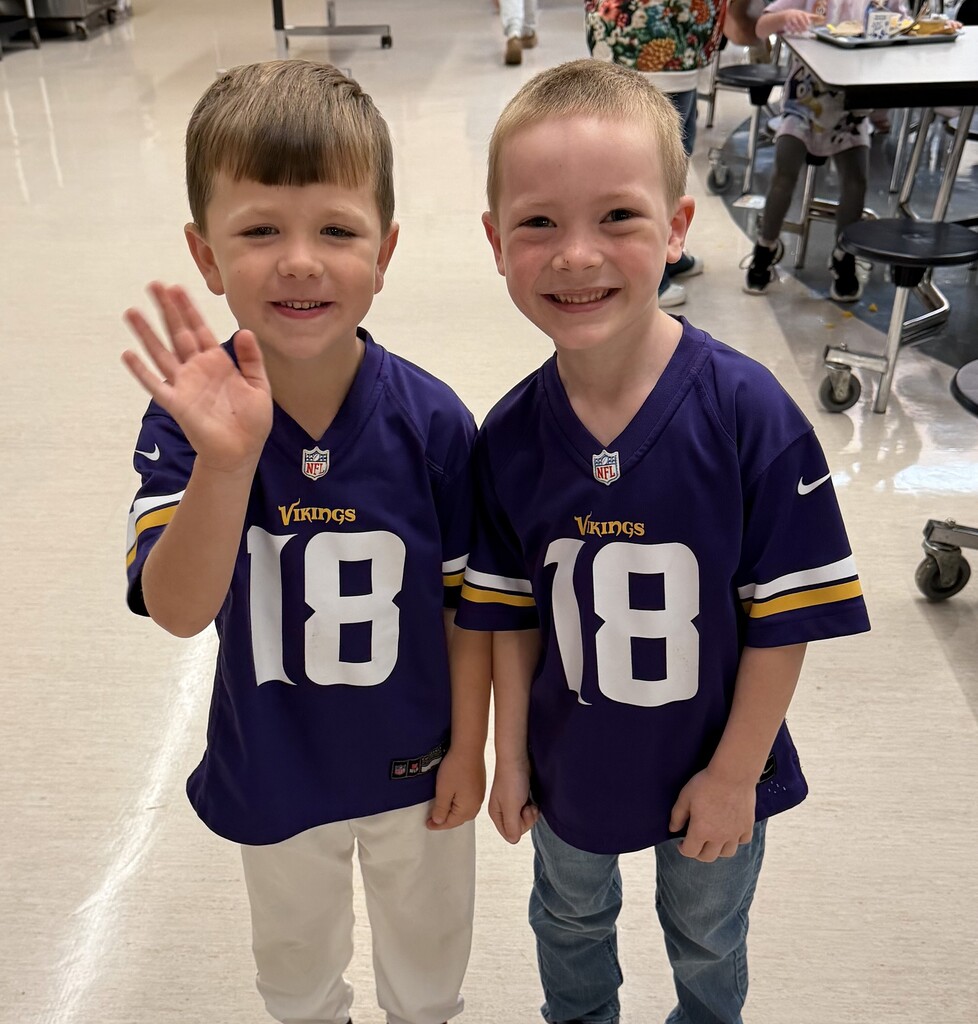 two male kindergarten students twinning in their Vikings jerseys