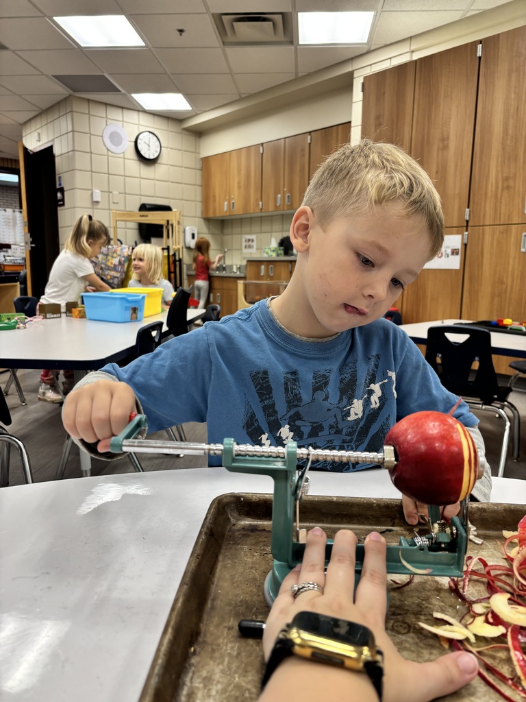 a Preschooler peeling an apple