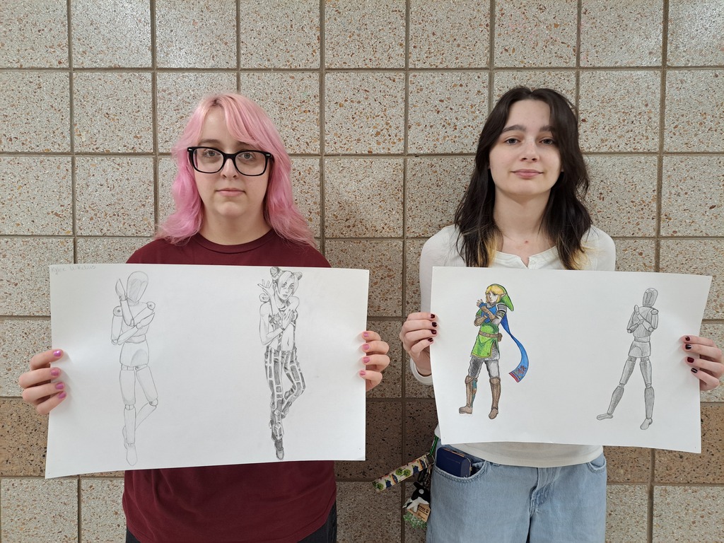 two female students with mannequin drawings