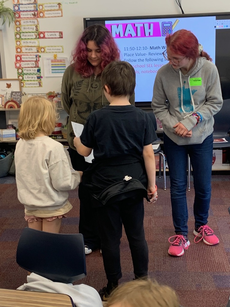 two HS school students helping two CRES students during their children's lit class
