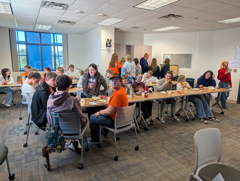 CIS students siiting at a table having lunch at CLC