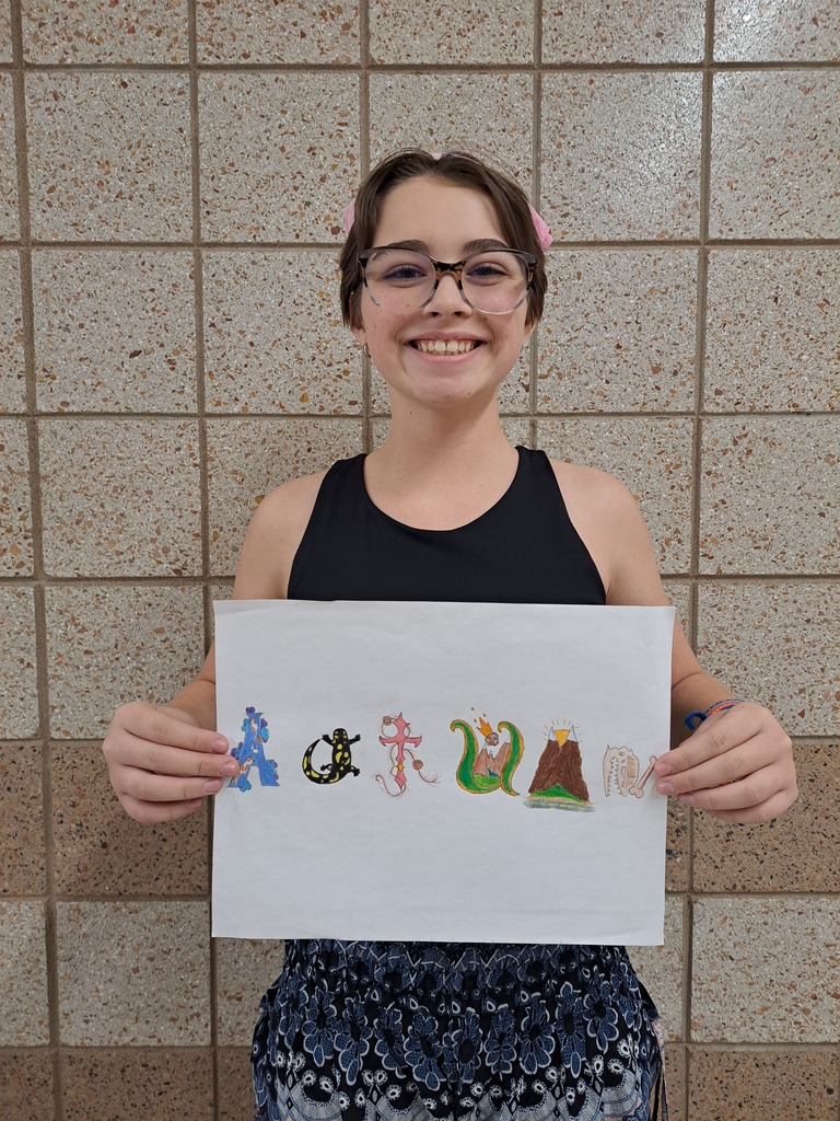 Female student holding her name art