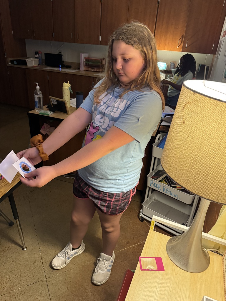 Student holding paper.