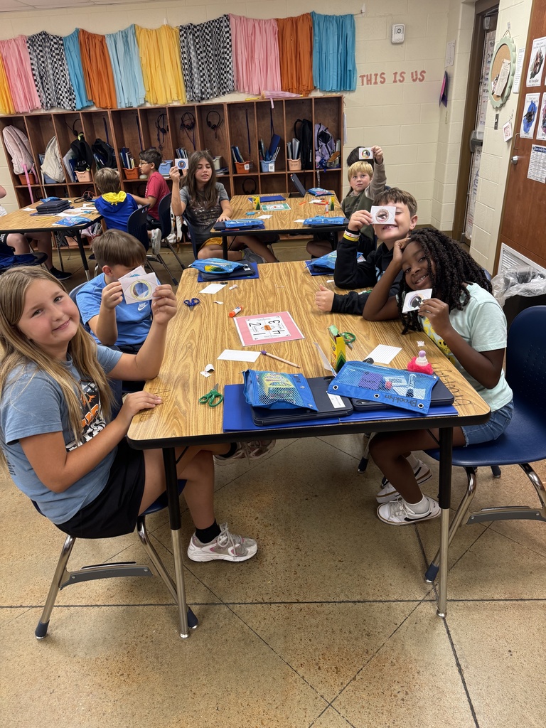 Students sitting at table.