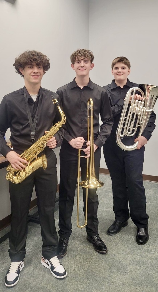 Three students holding instruments