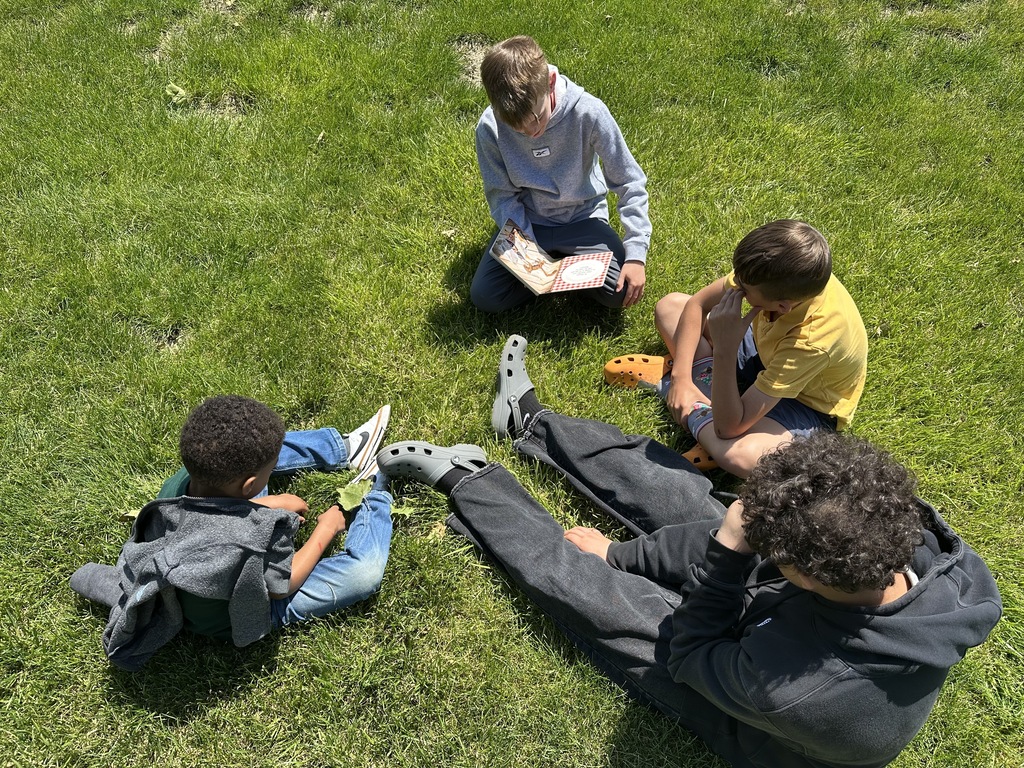 Kids reading outside