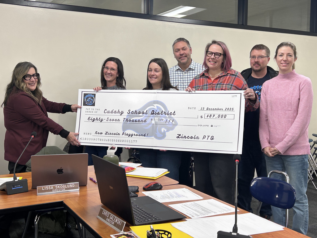 picture of the Lincoln PTO donating a check at the school board meeting
