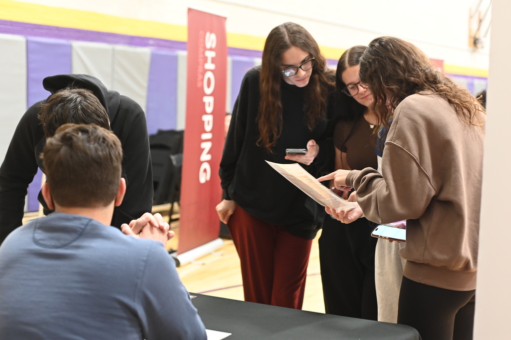 picture of 3 students reading a document