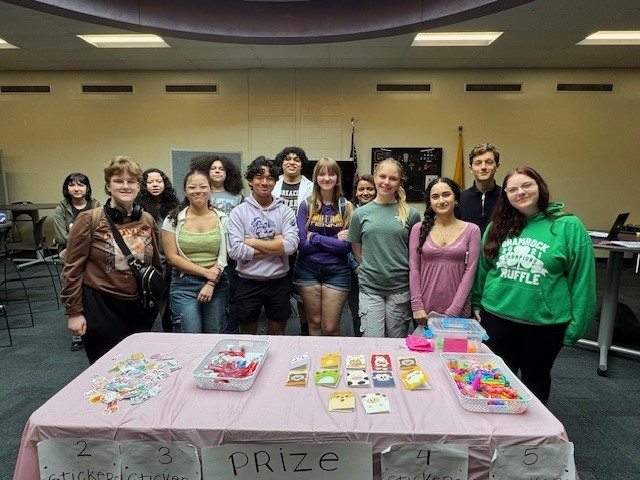 picture of high school students around a prize table