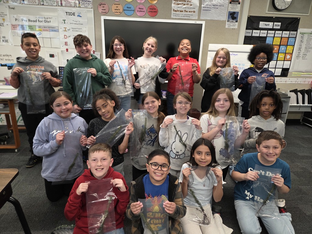 picture of 4th graders holding their saplings