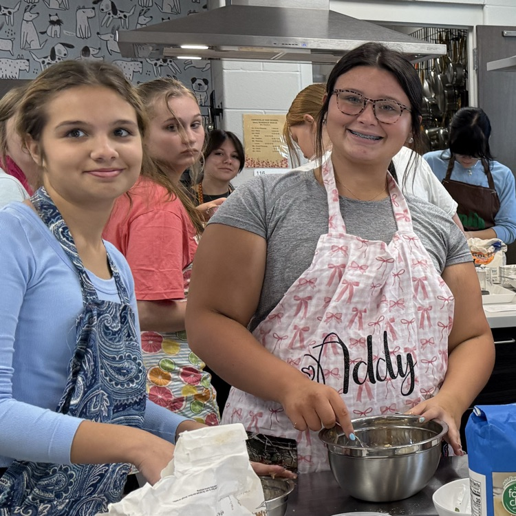 wearing aprons they made in class!