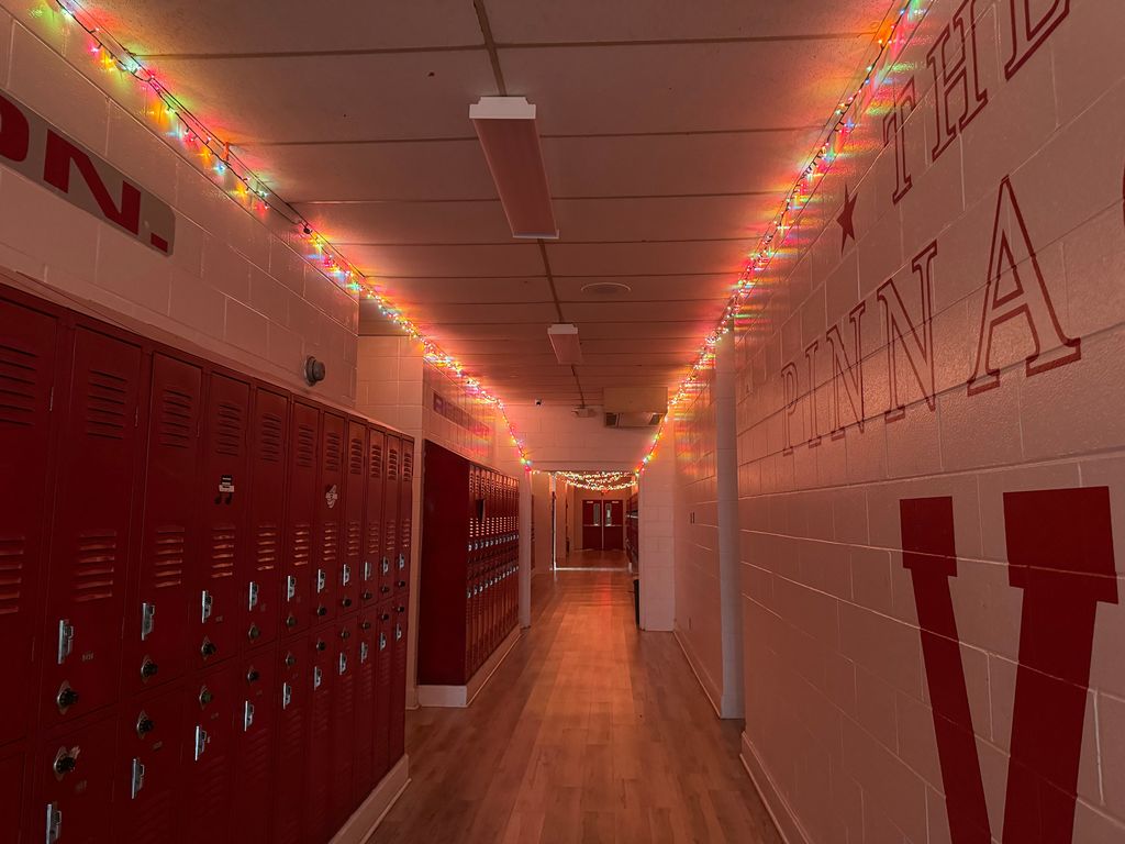 Hall with Christmas lights hanging along the corners of the ceiling