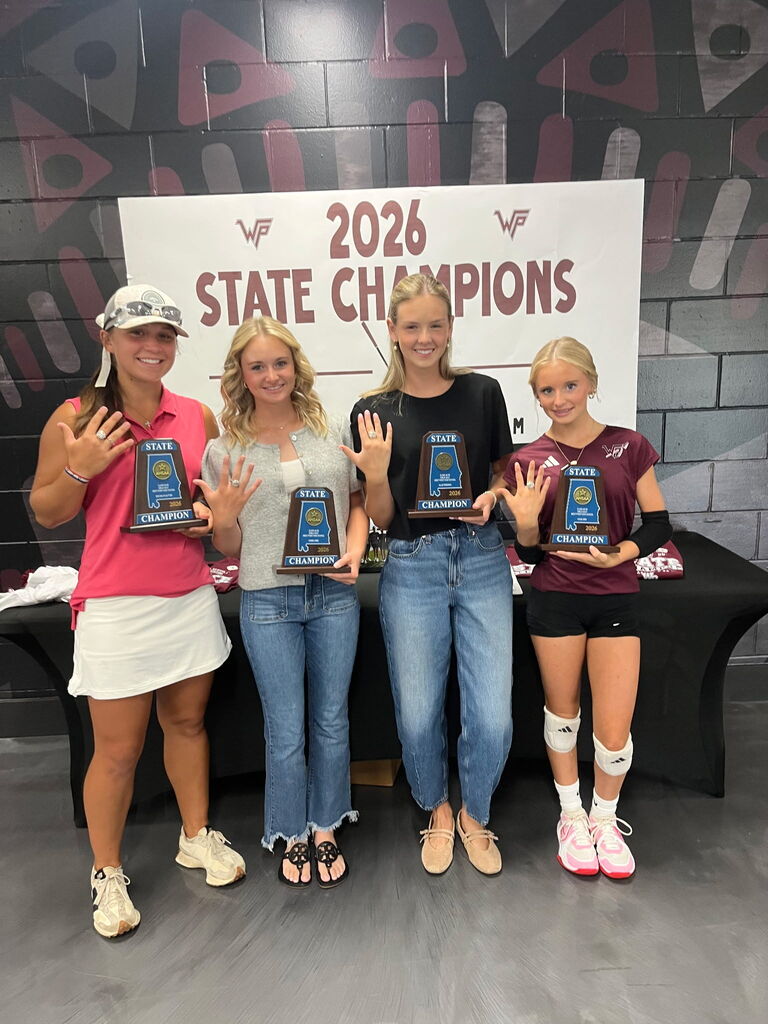 Four women pose with trophies in front of a backdrop that says "2026 State Champions".