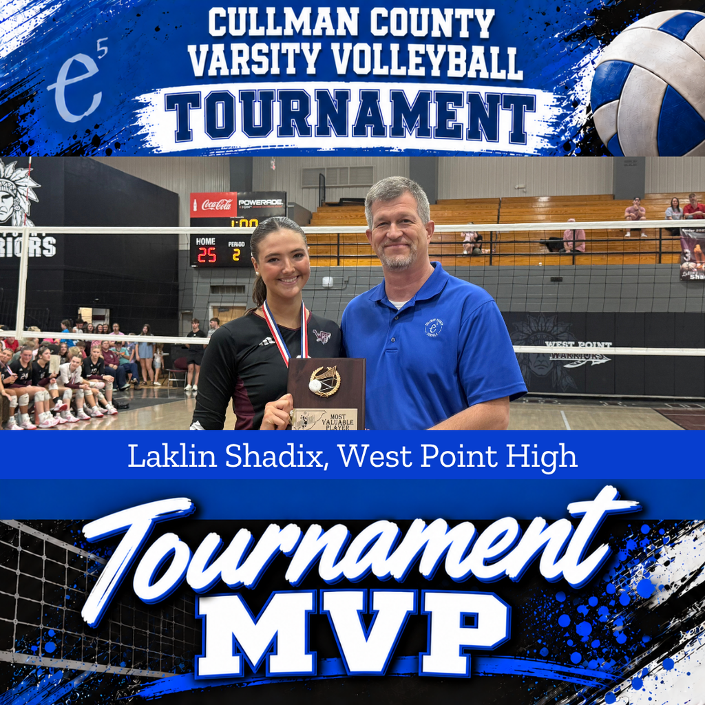 Two people in a gym. A female athlete holds a trophy. A male stands next to her.