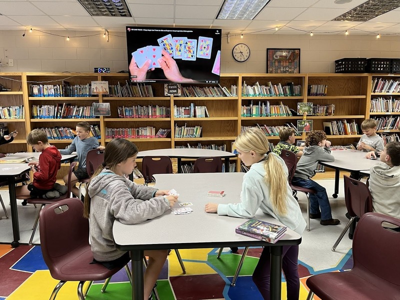 students learning magic tricks