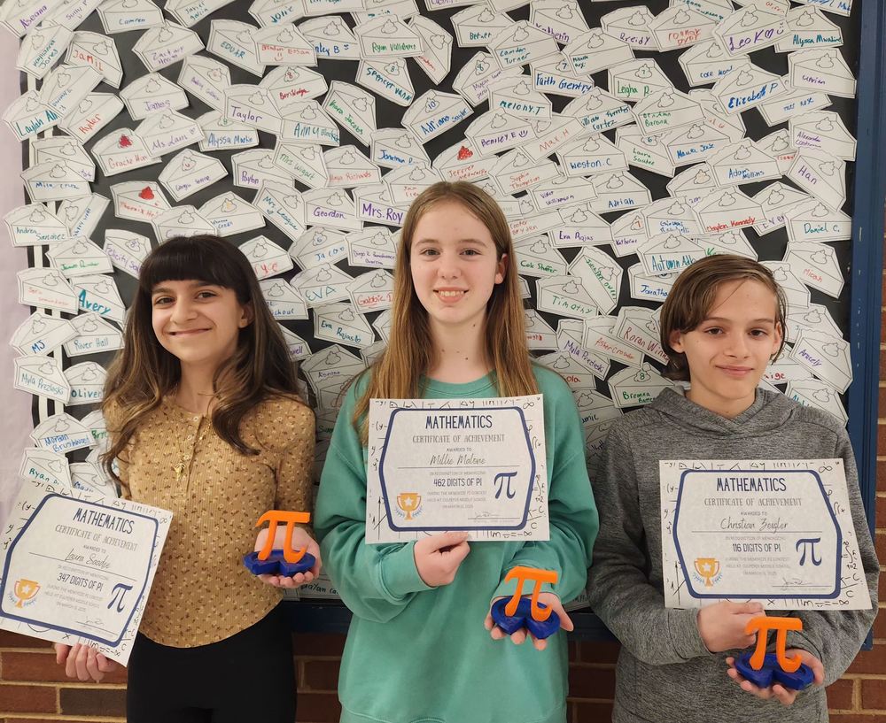 3 students holding certificate and Pi trophies