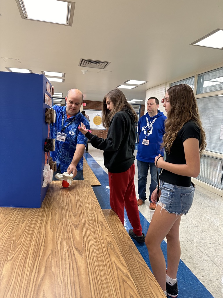 Students picking a prize for winning the perfect attendance award.
