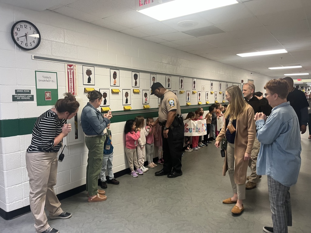 Students and staff line the hallways to say goodbye to Deputy White