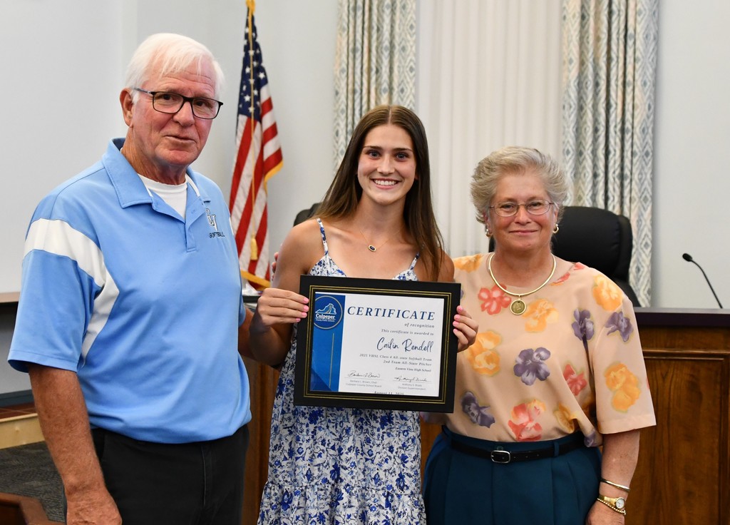 Cailin Rendell, Eastern View High School student, stands smiling and holding a certificate recognizing her as 2nd Team All-State Pitcher for the 2025 VHSL Class 4 All-State Softball Team, alongside sponsor Lonnie Myers and a School Board member during a recognition ceremony."
