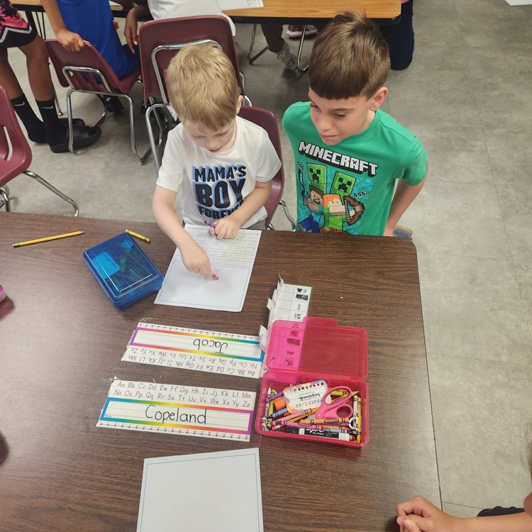 Mr. Hallett's fifth graders worked with our kindergartners yesterday on writing their name!