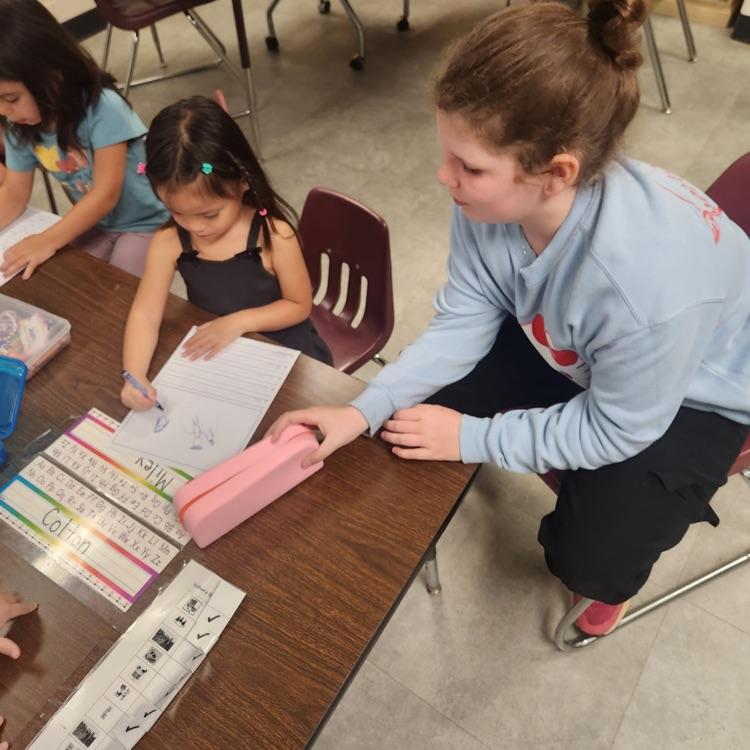 Mr. Hallett's fifth graders worked with our kindergartners yesterday on writing their name!