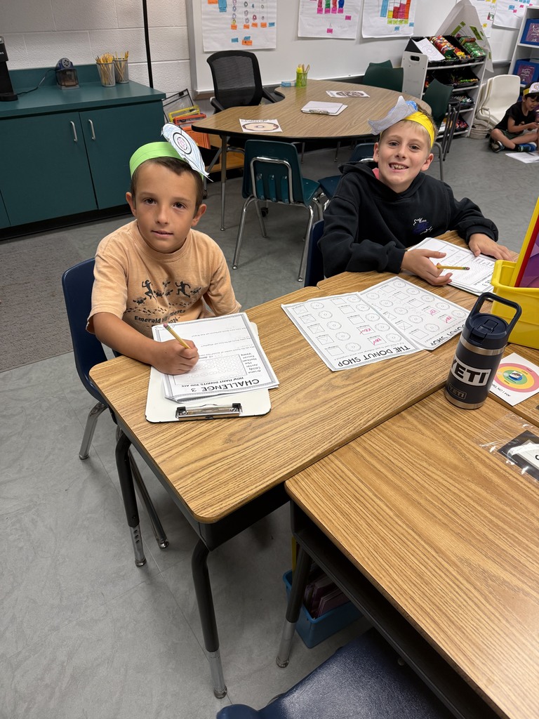 Students sitting at a desk completing donut day challenges