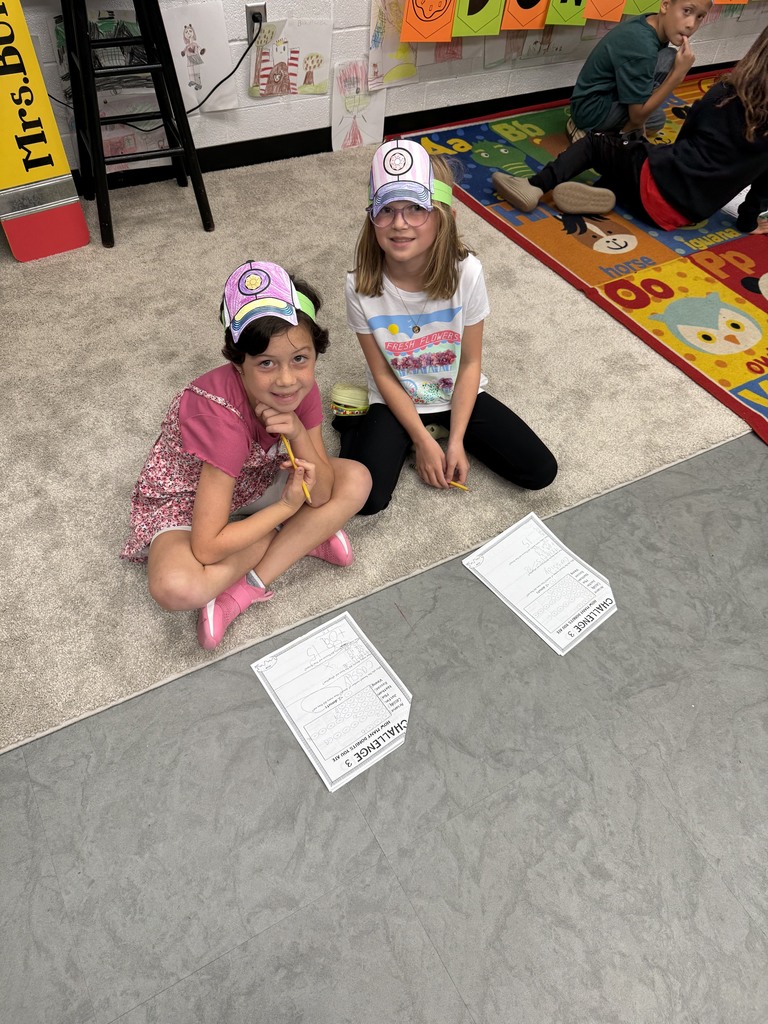Students sitting on a rug completing donut day challenges