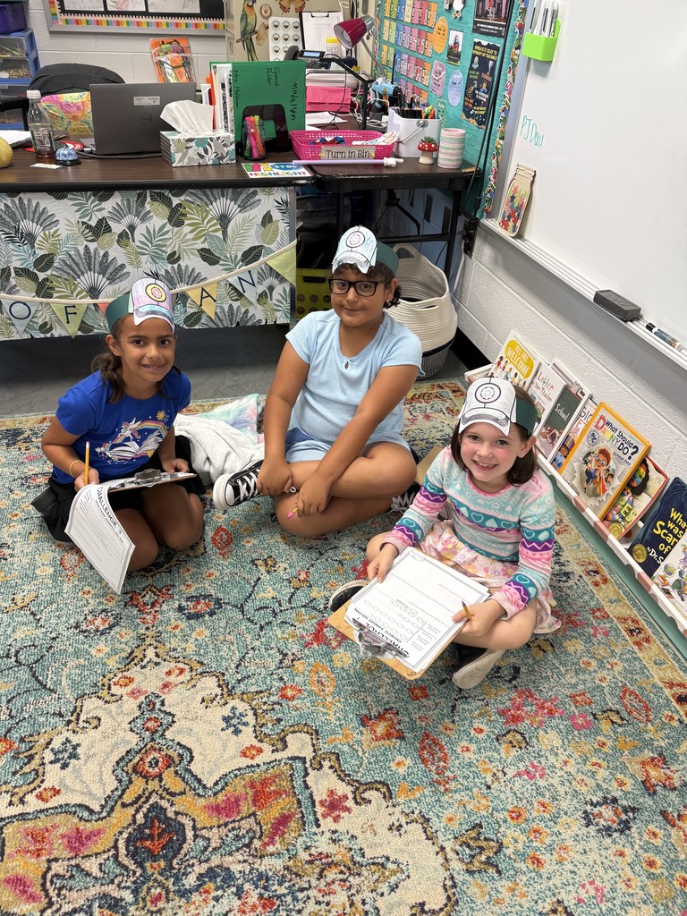 Students sitting on a rug completing donut day challenges