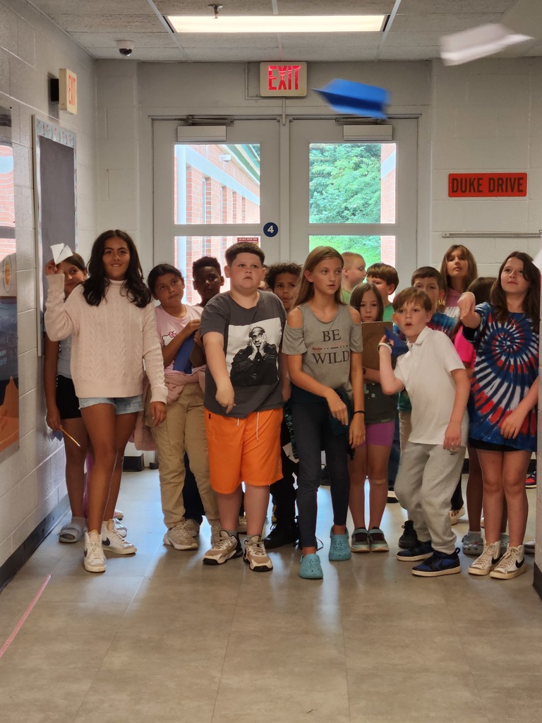 Mr. Berger's 5th Graders were practicing the scientific method to determine which type of paper would make the best paper airplane.  These pictures show their experiments in flight!