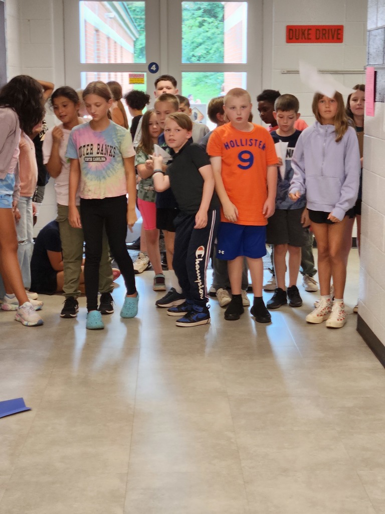 Mr. Berger's 5th Graders were practicing the scientific method to determine which type of paper would make the best paper airplane.  These pictures show their experiments in flight!