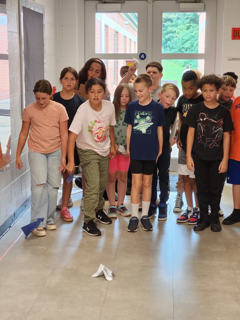 Mr. Berger's 5th Graders were practicing the scientific method to determine which type of paper would make the best paper airplane.  These pictures show their experiments in flight!