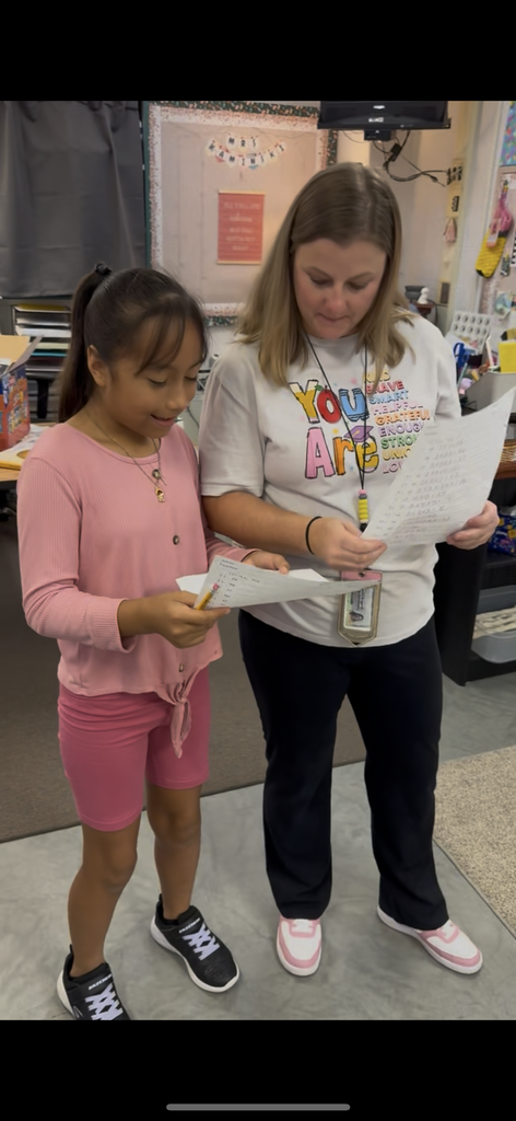 Teacher helping student with a math problem