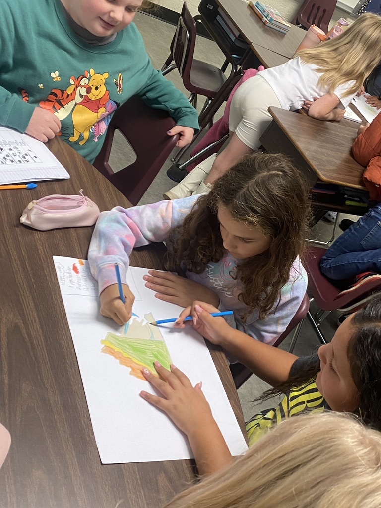 Students in Miss Simpson's 4th Grade class are seen here working on Virginia maps as a cumulative project identifying regions, major waterways, as well as each region's top products and industries. 